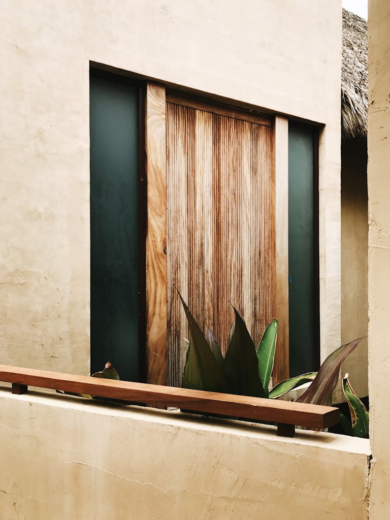 A Rustic Wooden Doorway Framed By Plants Capturing The Essence Of Mexican Architecture In Sayulita. 29904629 768x1024