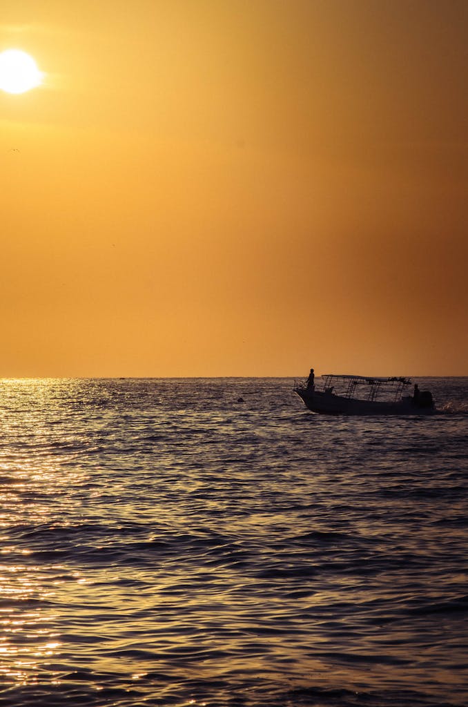 A Serene Sunset Over Sayulita Mexico With A Fishing Boat Silhouette On Sunlit Waters. 32786930 678x1024