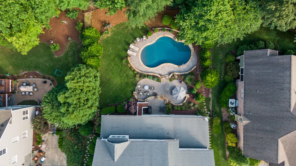 Aerial Shot Of A Suburban Backyard In Wake Forest Nc Featuring A Swimming Pool Garden And Seating Area. 12700523 1024x575