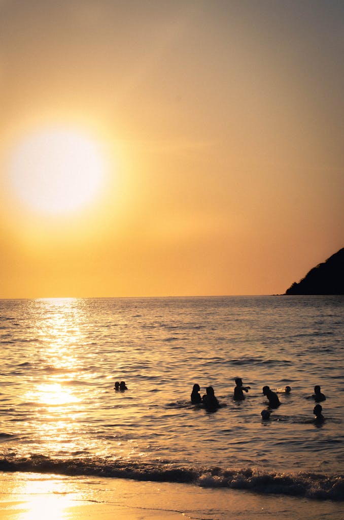 silhouetted swimmers enjoy a serene sunset at sayulita beach mexico. 32786932 678x1024.jpg