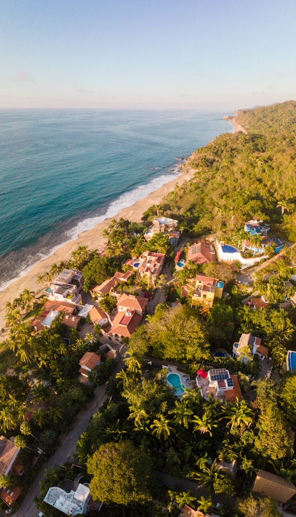 Stunning Aerial View Of Sayulita Village On The Pacific Coast Showcasing Houses And Lush Greenery. 20122033 587x1024